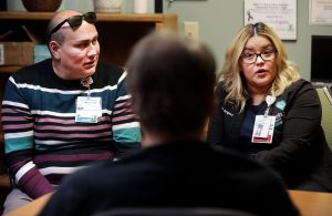 Chiricahua Clinic Community health worker Martin Rubio and Care Coordinator Jannet Rodriguez talk about financial aid with a patient last week at the Sierra Vista Facility. Mark Levy Herald/Review