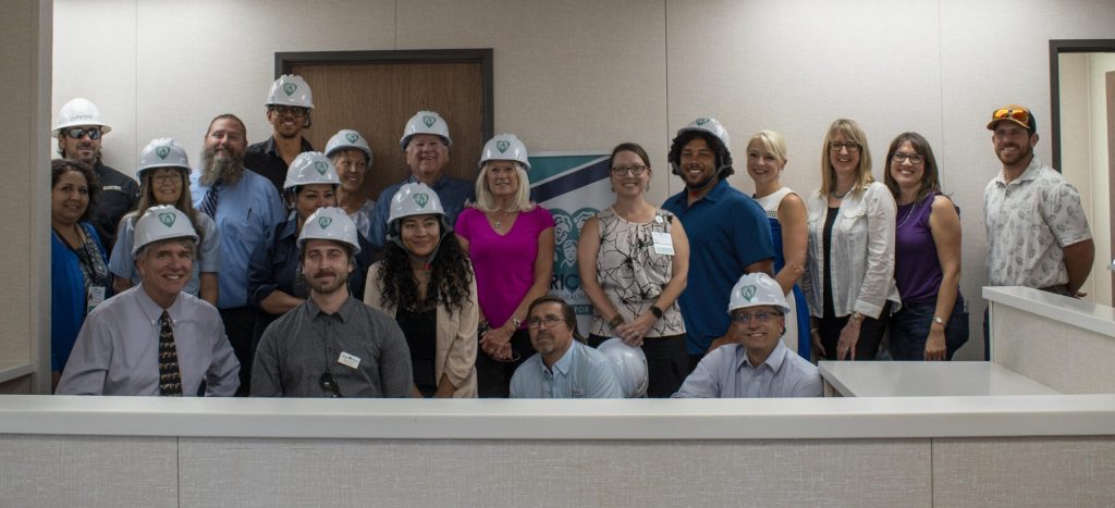 Group of community members and staff touring the interior of the new Chiricahua Willcox Family Health Center during a walkthrough